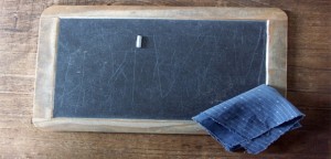 A school slate, with chalk and wiping cloth