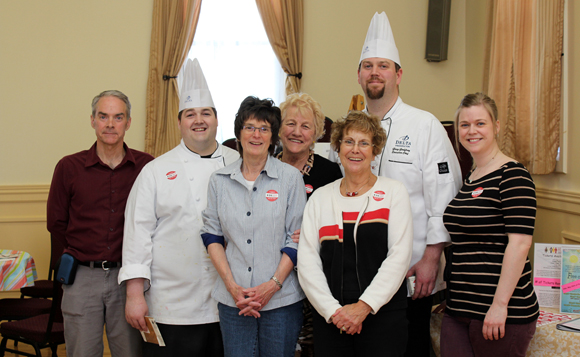 Volunteers Ken MacIntosh, Sandra Cooper, Joan Underhill and Jean Goodfellow, with Rachel Hebert of Mango - Horizon Health pose with Chef Chris Taylor and Executive Chef Greg Godfrey of the Delta Fredericton