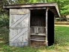 A tarpaper-covered outhouse very much like ours