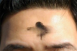 A smudged Ash Wednesday cross on the forehead