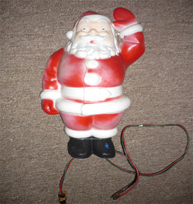 This is the actual Santa Claus ornament that Dad used to put up on top of the swing tree. The red paint on the plastic has faded over time, but it is still in good working condition.