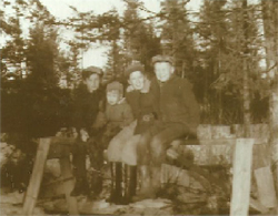 A picture from a few years ago of me and Johnny, with little brother Leonard between us, and friend Alton Underhill, sitting on a sawhorse in our back yard.